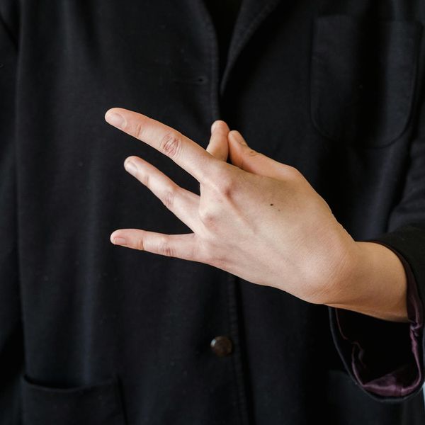Close-up of hands in a meditative mudra gesture, symbolizing inner connection.