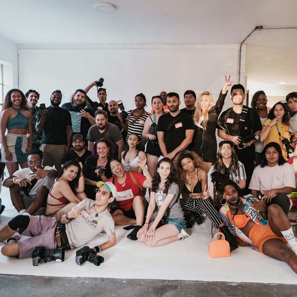 Diverse group of people smiling and looking relaxed in a bright studio.